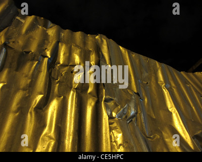 old high corrugated iron sheets fence outdoors at night Stock Photo