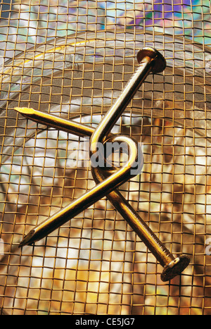 Nail puzzle ; nails puzzle ; twisted nails puzzle ; lock unlock ; bent nails puzzle ; Stock Photo