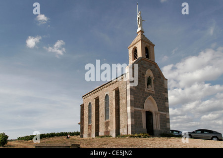 Chapelle de la Madone. The chapel on top of the hill above Fleurie, Burgundy. With statue of La Dame de la Pétoche on top. Stock Photo