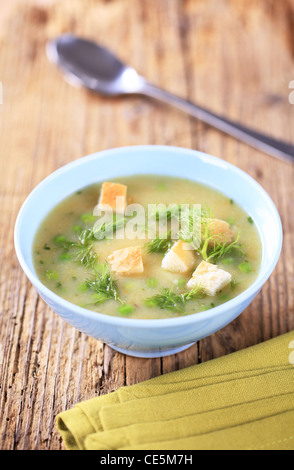 Bowl of pea soup with diced toasted bread Stock Photo