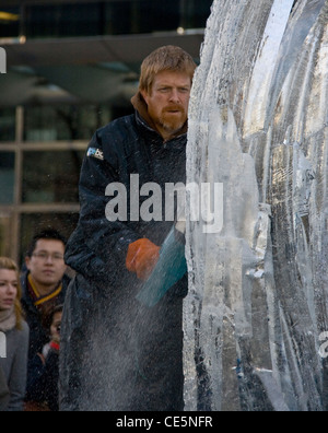 Ice sculptor working with chainsaw Ice Sculpting Festival Canary Wharf London England Europe Stock Photo