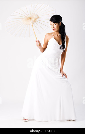 Young beautiful bride with white umbrella Stock Photo