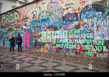 people walking in front of the John Lennon tribute wall in the Mala Strana district of Prague, Czech Republic Stock Photo