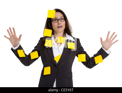 Stressed out business woman with numerous post-it notes stuck on her. White background. Stock Photo