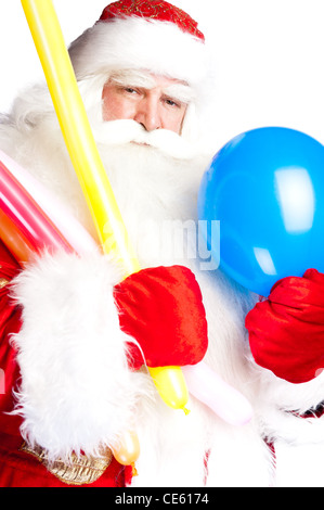 Traditional Santa Claus holding balloons for children. Isolated on white. Stock Photo