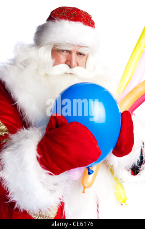 Traditional Santa Claus holding balloons for children. Isolated on white. Stock Photo