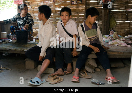 Elementary school boys are waiting for a cook to prepare lunch in the rural village of Ban Baumlao, Laos. Stock Photo