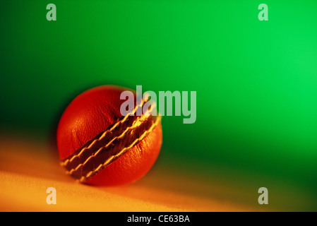 Cricket ball on green background Stock Photo
