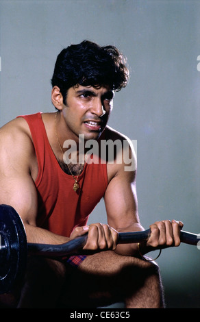 Indian man exercising lifting weights ; India ; asia ; MR#139 Stock Photo