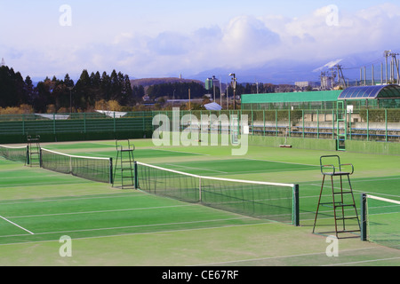 General view of few tennis courts in a sports complex at the margin of a city. Stock Photo