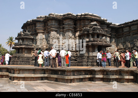 tourist enjoying the beauty of stone sculptures in chennakeshava temple,belur,karnataka,india. Stock Photo