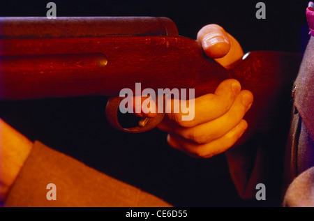 Finger on trigger of gun Stock Photo