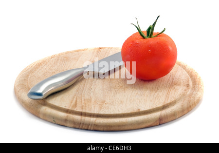a fresh tomato is on a board Stock Photo