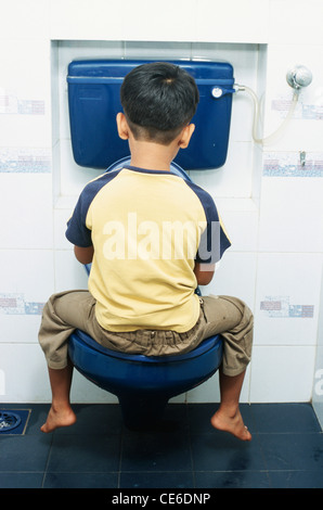 small young boy sitting on commode in toilet   MR#152 Stock Photo
