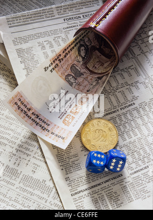 FORMER 50 IRISH POUNDS BANKNOTE + 1 GOLD ECU - European Currency Unit - COIN + SHAKER + 2 EUROPEAN DICE ON FINANCIAL NEWSPAPER Stock Photo