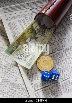 FORMER 5,000 PORTUGUESE ESCUDOS BANKNOTE + 1 GOLD ECU - European Currency Unit - COIN + SHAKER + 2 DICE ON FINANCIAL NEWSPAPER Stock Photo