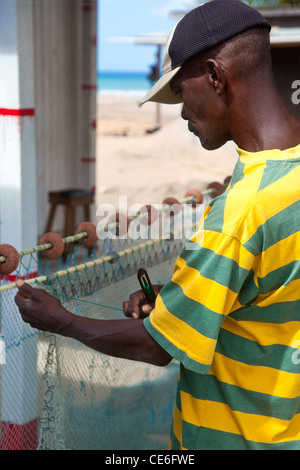 Fisherman mending his nets in Canaries, St. Lucia, West Indies Stock Photo