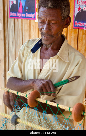 Fisherman mending his nets in Canaries, St. Lucia, West Indies Stock Photo