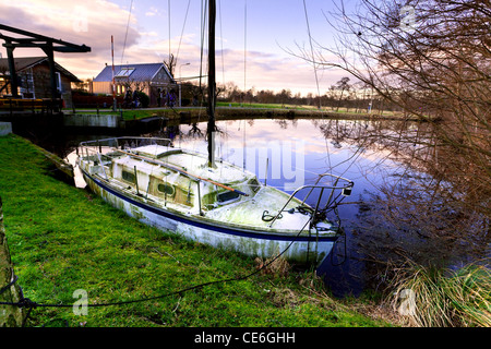 old dirty forgotten yacht over sky on sunset Stock Photo