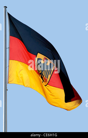 German flag with the Federal eagle at the mast in front of the Federal Chancellery in Berlin. Stock Photo