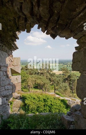 A view through a hole in Beeston Castle wall looking over the Cheshire Countryside England. Stock Photo