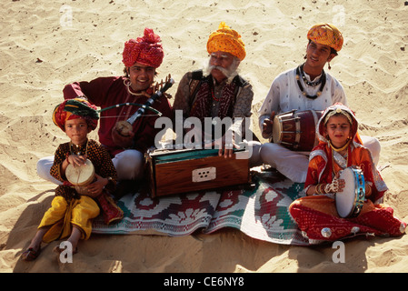 Indian folk musicians family playing musical instruments in desert ; India ; Asia ; MR#657 Stock Photo