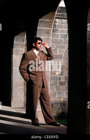 Businessman in brown suit jacket dark glasses standing in archway   MR#139 Stock Photo
