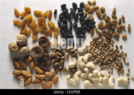 dry fruits dried fruit mixed assorted almonds figs raisins cashew nuts pistachio on white background Stock Photo