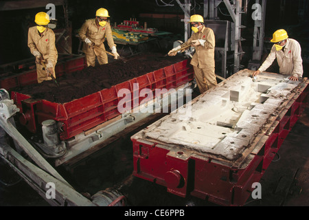 Indian workers wearing masks and helmets working in factory ; india ; asia Stock Photo