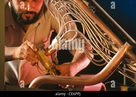 Indian man worker working in engineering factory ; india ; asia Stock Photo