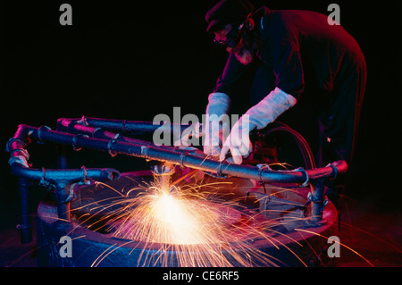 Indian man welding working in engineering workshop ; india ; asia Stock Photo