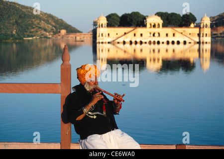 indian rajasthani man folk musician playing wind musical instrument flute jaipur rajasthan india MR#657 Stock Photo