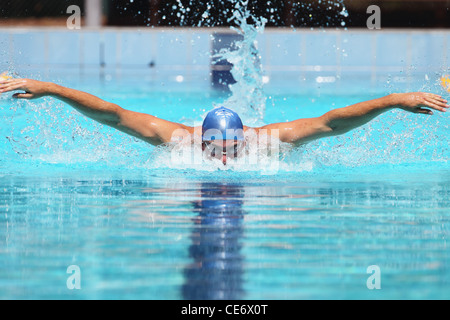 Young Man Swimming Butterfly Stroke Stock Photo