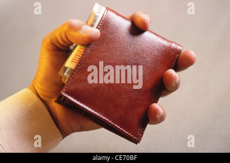 NVM 83938 : man holding wallet purse full of paper money Indian rupees 1000 one thousand notes india Stock Photo