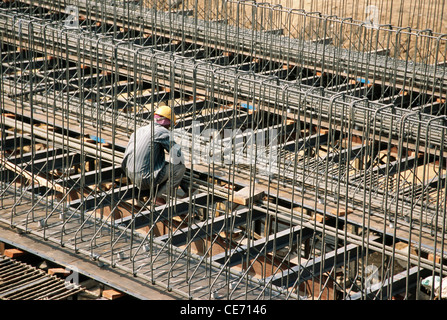 Indian man working steel frame at construction site ; india ; asia Stock Photo