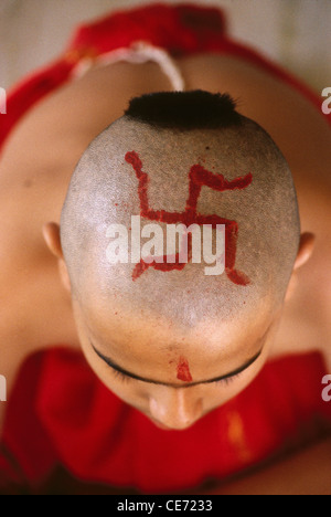 Red Swastik sign on bald head of child on Thread Ceremony Mumbai Bombay Maharashtra India - Model released Stock Photo