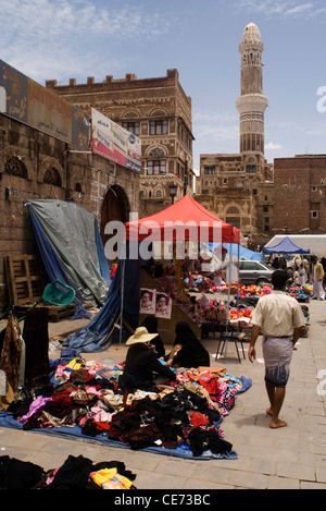 Market in the souk and the mosque tower in the old city of Sana'a, a UNESCO World Heritage Site, Yemen, Western Asia. Stock Photo