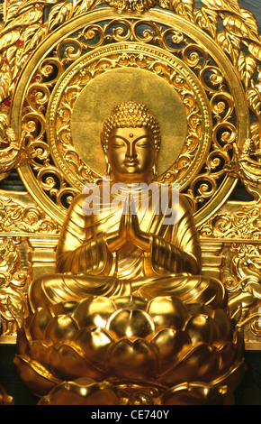 Buddha statue of gold in namaste posture sitting on lotus flower at the gompa at shanti stupa in leh ; ladakh ; Jammu and Kashmir ; india ; asia Stock Photo