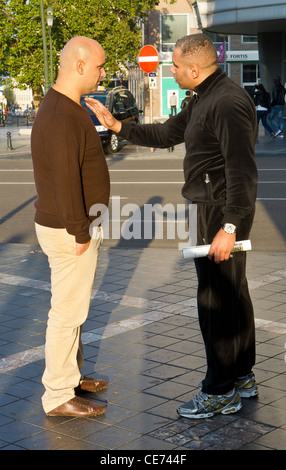 2 two man men argue arguing in serious conversation Stock Photo