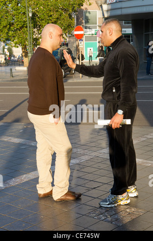 2 two man men argue arguing in serious conversation Stock Photo