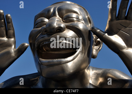 Sculpture by Chinese modern artist Yue Minjun, arguably of the Cynical Realist School, on the forecourt of Art Today Museum. Stock Photo