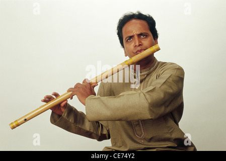 Man playing large wind instrument flute ; No Model Release ; only for editorial use Stock Photo