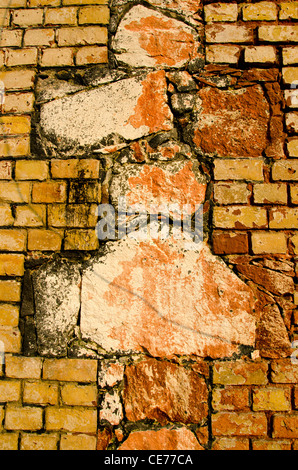 Architectural old wall background. Interesting architecture made of different bricks. Cross sign. Stock Photo
