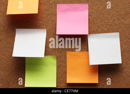 Some different colored clear papers at cork board Stock Photo