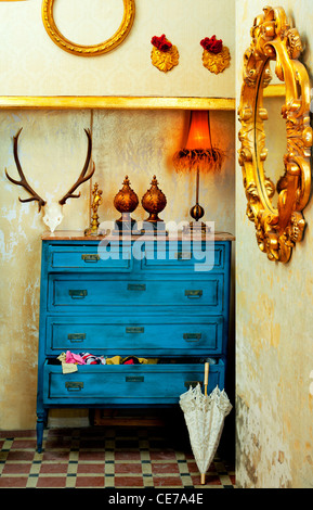 baroque grunge vintage house with blue drawer and golden mirror Stock Photo
