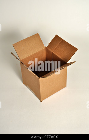 A empty cardboard box sits on a white background. Stock Photo
