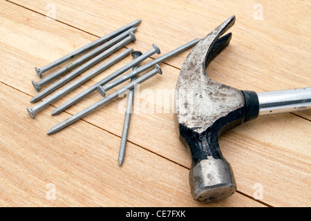 Old hammer and nails on wood background Stock Photo