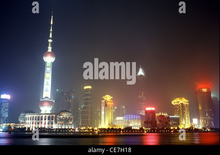 Skyline of the lit up buildings in Pudong Xinqu from across Huangpu River Shanghai China Stock Photo