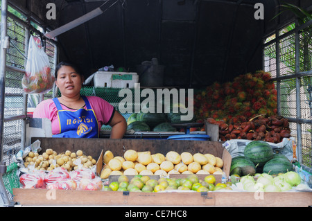 street market seller, girl, on back of truck, selling fruit and potatoes, off Sukhumvit Road, Bangkok Stock Photo