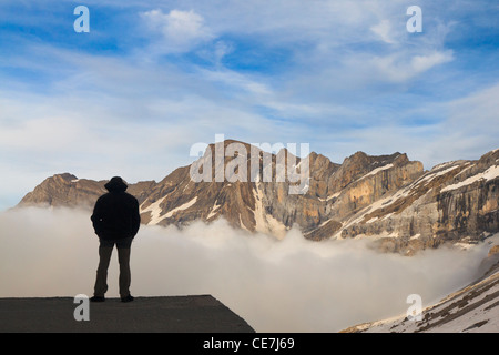 Mountaineer in front of Petit Astazou and Marbore Peak. Cirque de Gavarnie. Pyrenees National Park. France. Stock Photo
